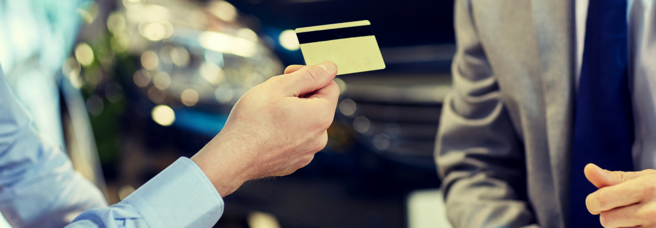 Customer handing credit card to salesperson
