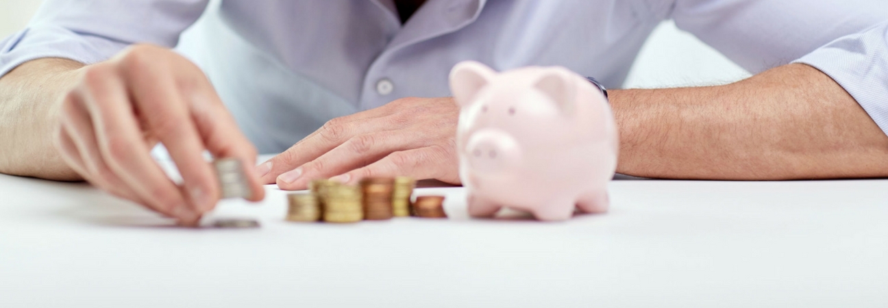 A close up of a person with coins and piggy bank