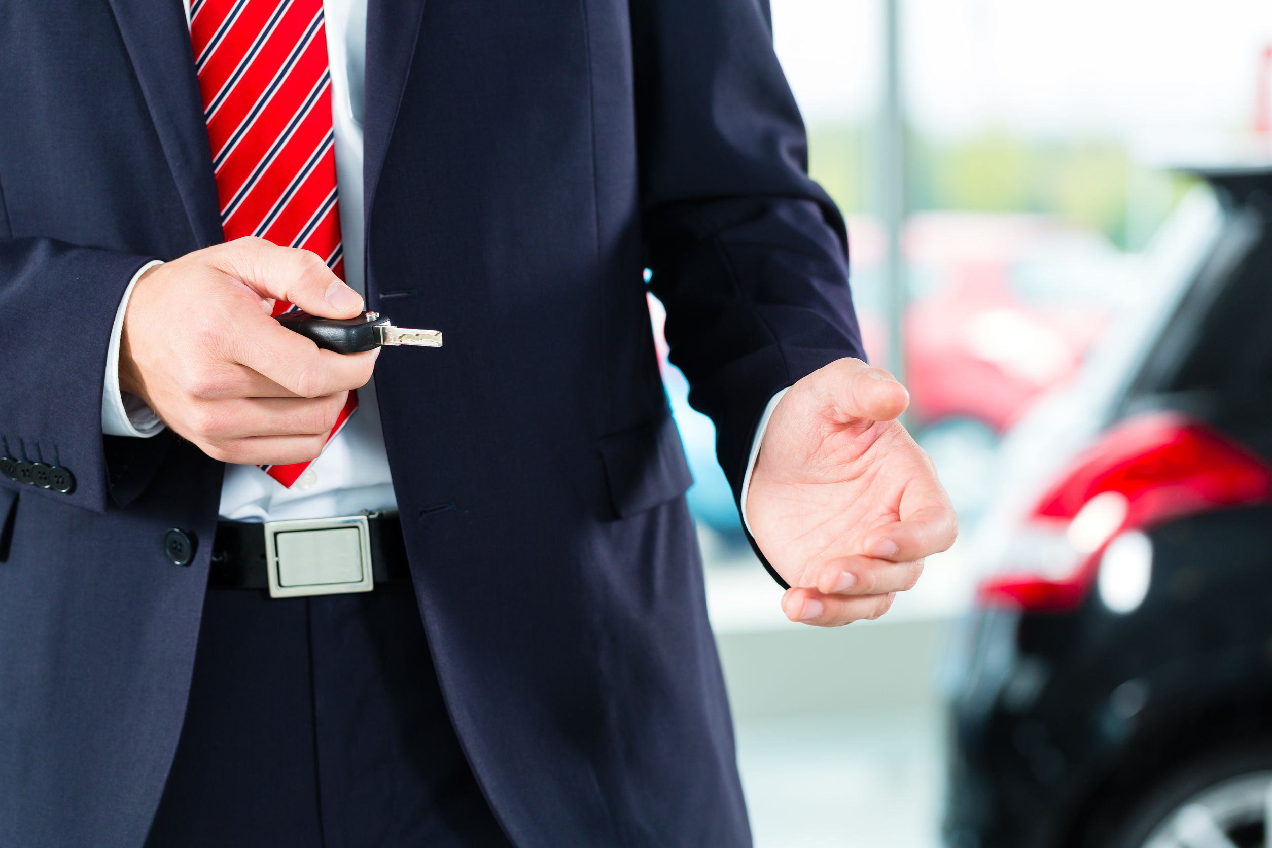 Car salesman holding key