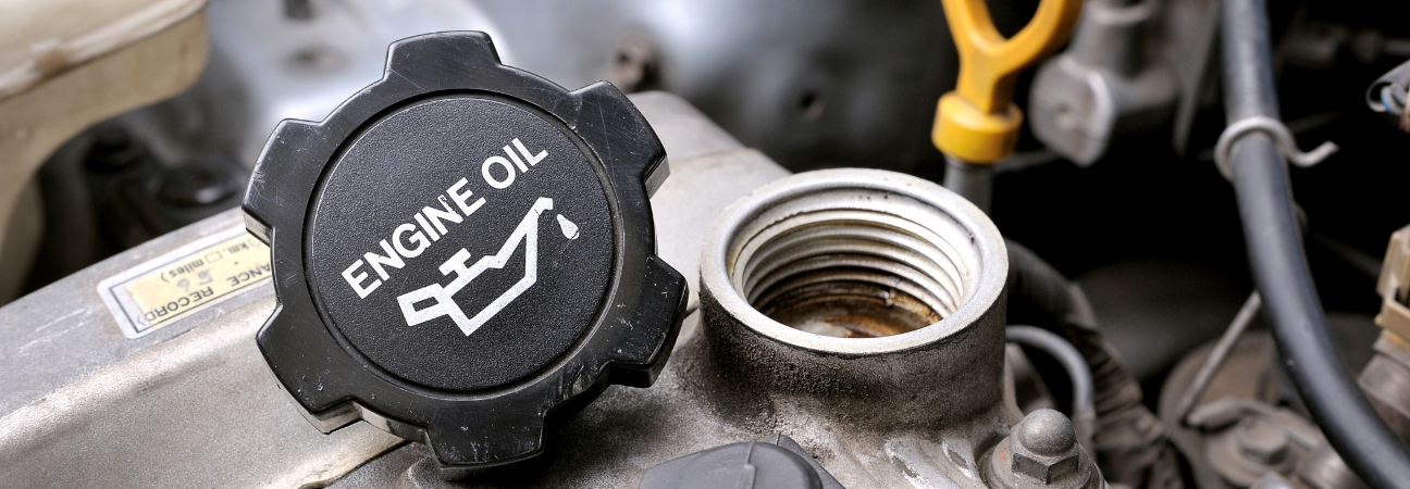 A close-up of an engine oil tank cap for a car engine featured in a blog post about oil change