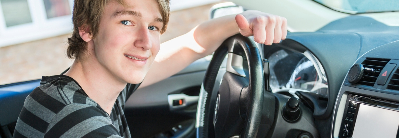 Teen driver behind wheel of car