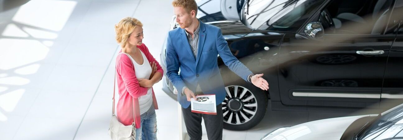 a car salesmen helping a customer find the right car for them